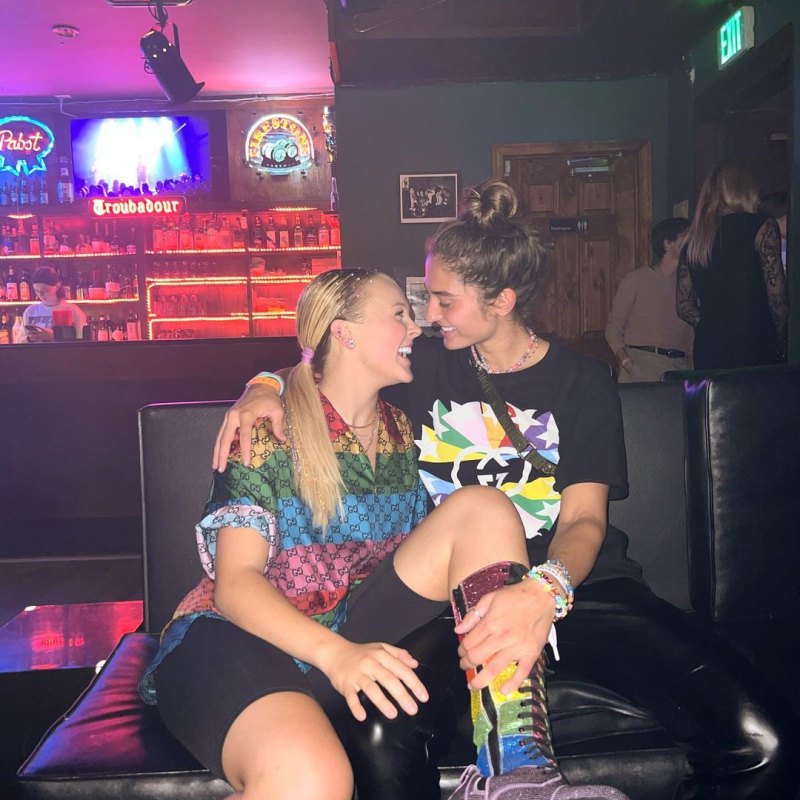 JoJo Siwa kisses girlfriend Kylie Prew as the couple hold hands and sing  together at outdoor concert